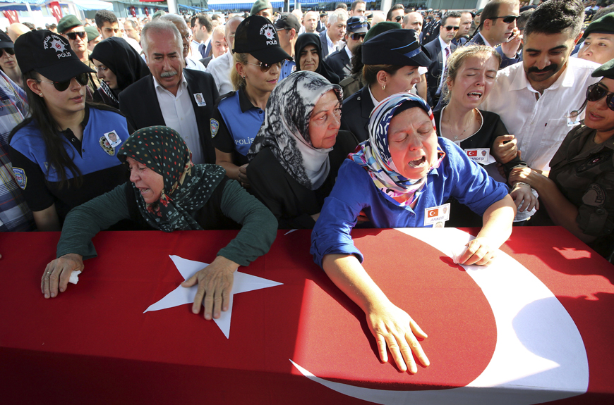 Hulya Aydin (right) the mother of Turkish police special operations officer Sahin Polat Aydin, one of the four officers killed on Monday in a landmine attack attributed to militants of  the Kurdistan Workers’ Party, or PKK, in Silopi, southeastern Turkey, cries over his Turish flag-draped coffin during a ceremony in Ankara, on Tuesday (AP photo)